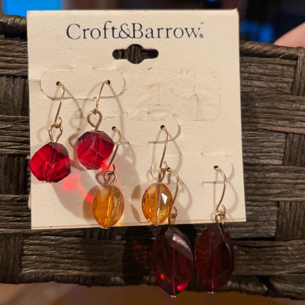 Three pair of earrings in fall colors. Red, orange, and brown.